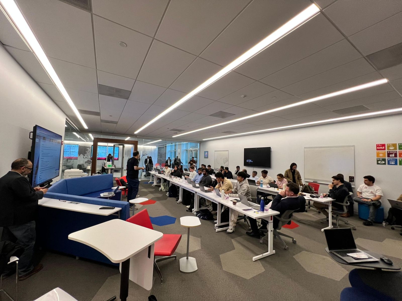 A full class of business owners working on laptops in Queens
