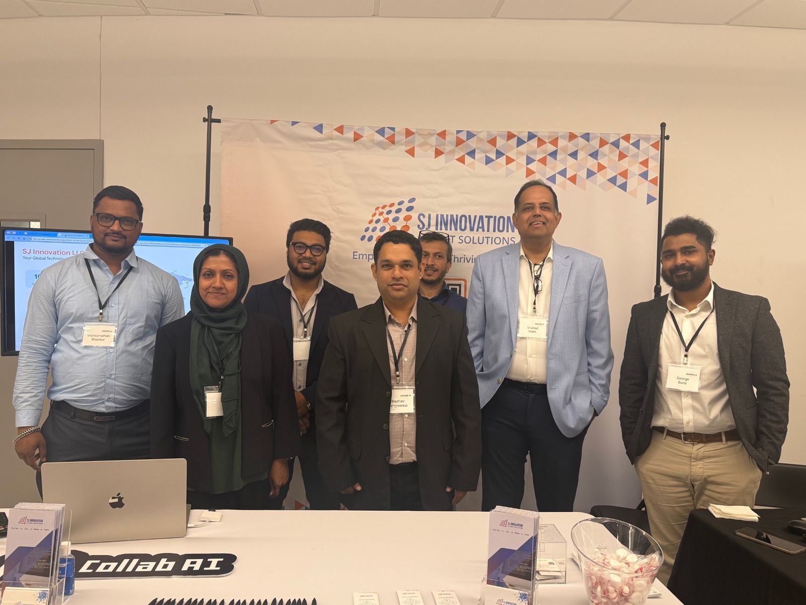 The SJ Innovation team at its table at a Queens AI event